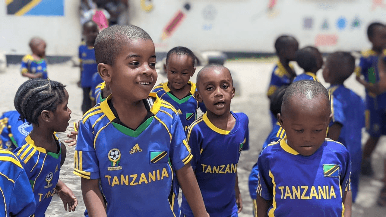 Amosi Schools students smiling outside in school uniform